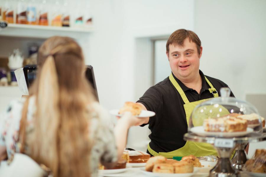 A young adult working in a bakery